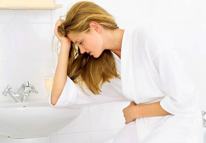 A woman worries about the symptoms of cystitis in the form of frequent and painful urination